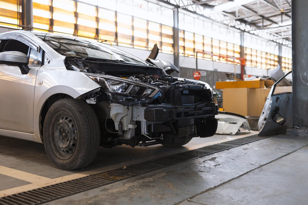 Damaged car with removed bumper after a collision, representing accident repair